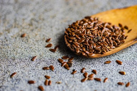 Overhead view of vintage wooden spoon with flax seeds