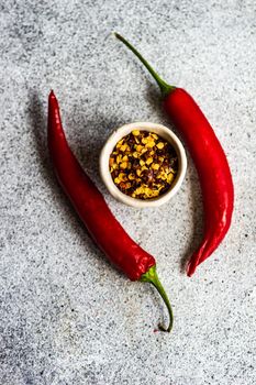 Bowl with pepper spice  on grey concrete table