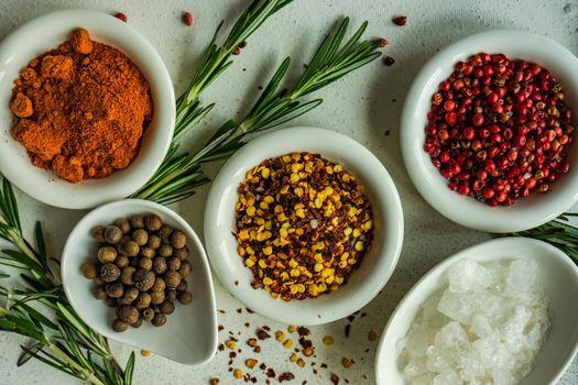 Spices in the bowls as a cooking frame on concrete table