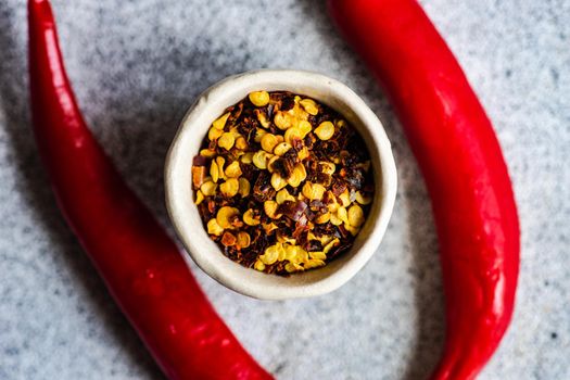 Bowl with pepper spice  on grey concrete table