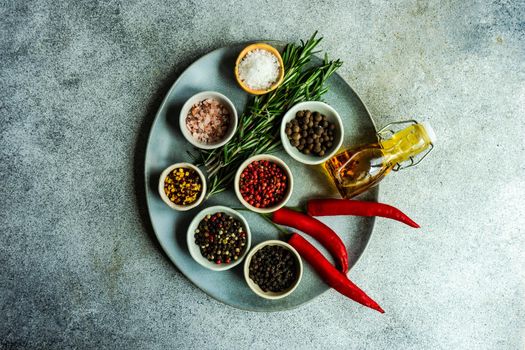 Plate with spices as a cooking concept on concrete table