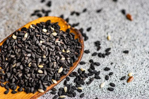 Overhead view of vintage wooden spoon with black sesame seeds