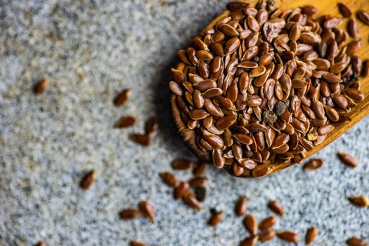 Overhead view of vintage wooden spoon with flax seeds