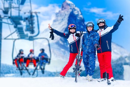 Smiling ski friends skiing alps resort.