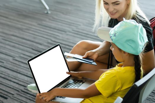 mother and daughter with laptop with blank screen.