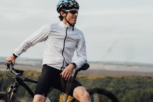 Professional Male Cyclist with Bike Outdoors, Adult Man Wearing Helmet and Protection Sport Glasses Looking Away, Copy Space