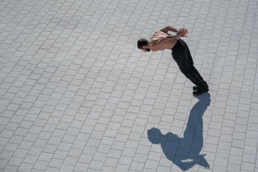 A man doing push-ups with flying outdoors