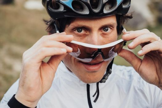 Close Up Portrait of Professional Male Cyclist, Adult Man Wearing Helmet and Protection Sport Glasses