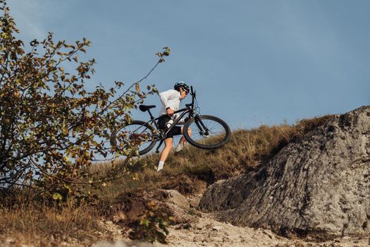 Professional Male Cyclist Carrying His Bike on Top of Hill, Adult Sportsman on Trail