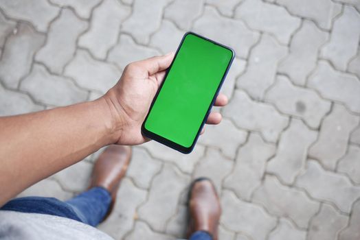 rear view of young man using smart phone at outdoor .