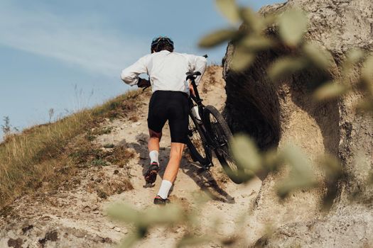 Professional Male Cyclist Carrying His Bike on Top of Hill, Adult Sportsman on Trail