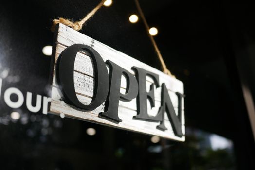 Open sign hanging front of cafe