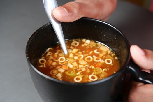 instant cup soup in a mug on table .