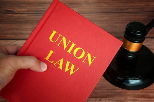 Union law text on law book with judge gavel on wooden desk background. Law concept