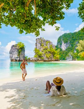 Koh Hong Island Krabi Thailand, a couple of men and women on the beach of Koh Hong, a tropical white beach with Asian women and European men in Krabi Thailand