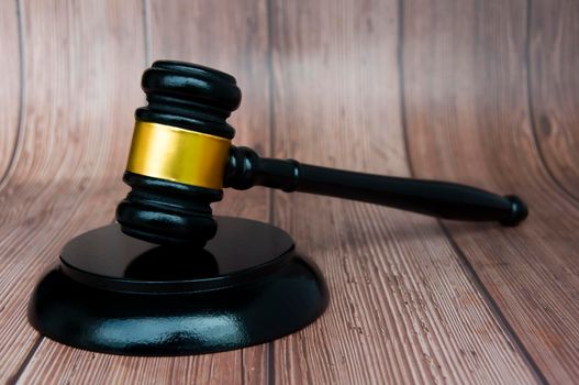 Judge gavel on wooden desk background with space customizable for text or ideas. Copy space and law concept