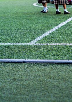 Children in the artificial turf of the school