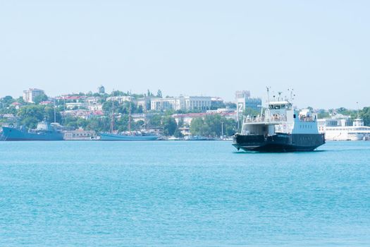 RUSSIA, CRIMEA - JUL 08, 2022: Sevastopol city crimea bay sea russia pier ferry transport port, for tourism seascape from transportation from istomin architecture, ukraine boat. Cityscape coast summertime, stage