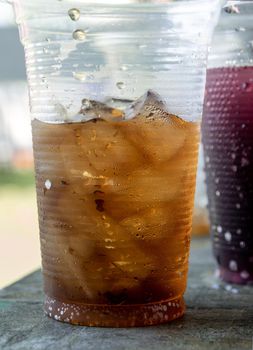 Soft drink and ice in the disposable plastic glasses