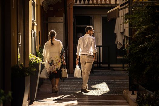 Rovigo, Italy 29 july 2022: Couple goes shopping in Italian historic city boutiques