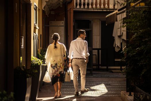 Rovigo, Italy 29 july 2022: Couple goes shopping in Italian historic city boutiques