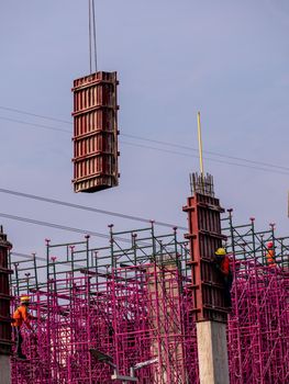 The pink scaffolding on the building under construction