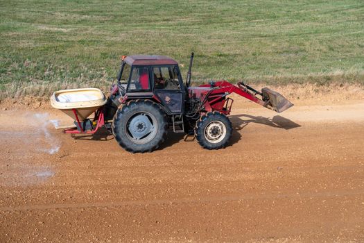 the tractor treats the chemistry of the autocross tracks before the races.