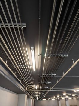 Tidy installation of Galvanized Electrical Metallic Tubing (EMT) Conduits on the ceiling of parking building