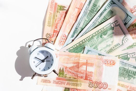Time value of money concept, analog clock on US dollar banknote, depicting receiving money today can be poised to increase the future value by investing