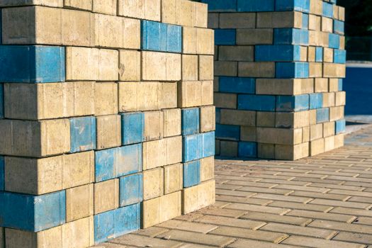 stacks of new colored paving slabs for paving paths stacked on a construction site in a city park. improvement of the city, paving of sites