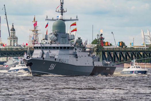 Russia, St. Petersburg, 28 July 2022: A lot of warships goes along the Neva River under open bridges at the time of the rehearsal of the celebration of the day of the Navy in sunny weather. High quality photo