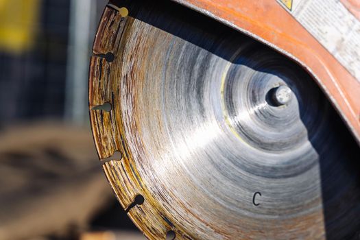 close-up of a saw with a disc for cutting concrete and paving slabs. gasoline hand saw on concrete