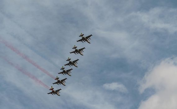 Russian Air Force planes paint the colors of the Russian flag in the sky on St. Petersburg during the celebration of the Day of the Navy. High quality photo