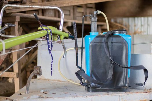 Shoulder-mounted pesticide sprayer for gardening and yard work. Agricultural sprayer. Knapsack battery sprayer for protecting trees and plants from diseases and pests