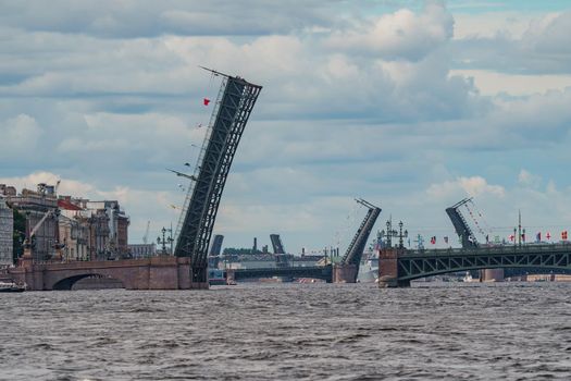 Russia, St. Petersburg, 28 July 2022: The Trinity Bridge is being opened for the passage of military corpables during the afternoon dress rehearsal of the celebration of the Day of the Navy. High quality photo