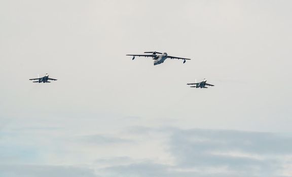 Russia, St. Petersburg, 28 July 2022: Military aircraft and helicopters of the air force fly on the city at the celebration of the Day of the Navy, amphibious and transport aircraft, anti-submarine. High quality photo