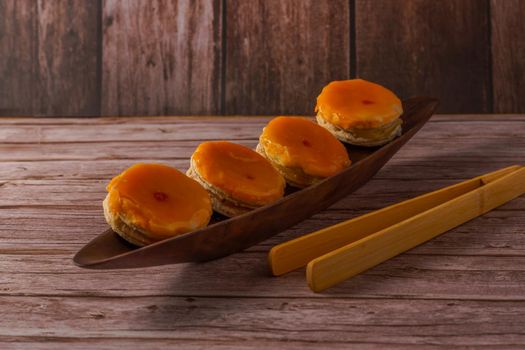 tortas locas or crazy cakes typical of andalucia, spain on a wooden bowl and some tongs