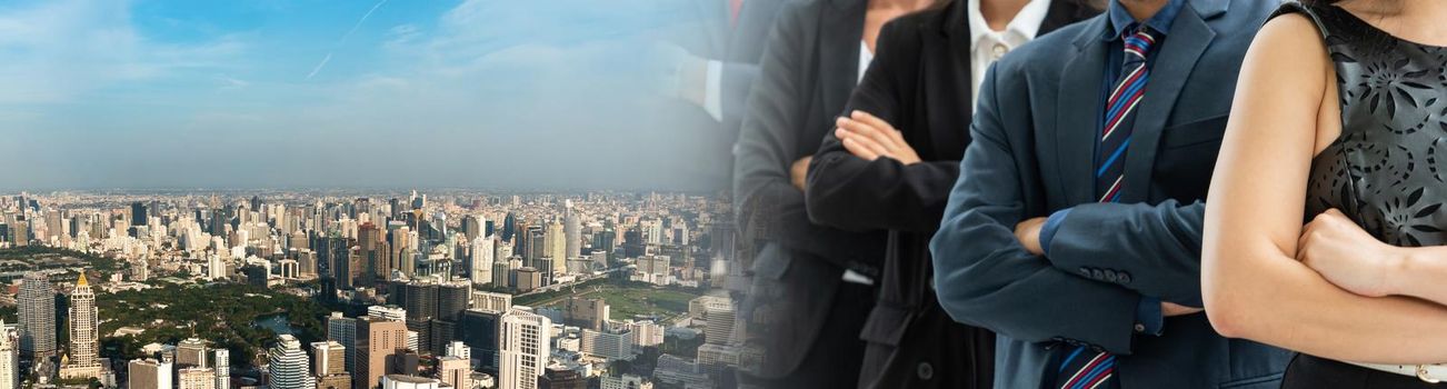 Successful business people standing together widen out showing strong relationship of worker community. A team of businessman and businesswoman expressing a strong group teamwork at the modern office.