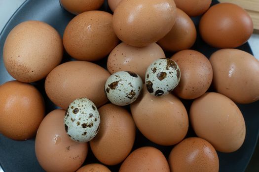 Fresh homemade chicken eggs lie on a server plate. High quality photo