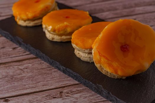 tortas locas or crazy cakes typical from andalucia, spain on a black tile on a wood background