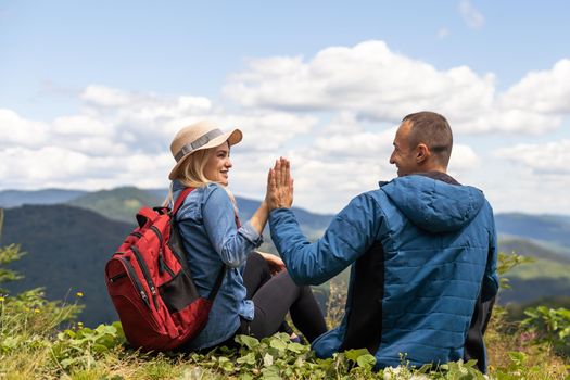 Couple travelers Man and Woman sitting relaxing mountains, view Love and Travel happy emotions Lifestyle concept. Young family traveling active adventure vacations.