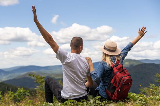 Couple travelers Man and Woman sitting relaxing mountains, view Love and Travel happy emotions Lifestyle concept. Young family traveling active adventure vacations.