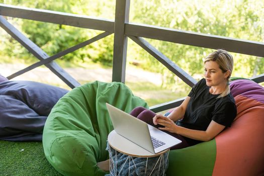 Work from home or study online, concept with a woman working at laptop outdoor on terrace.