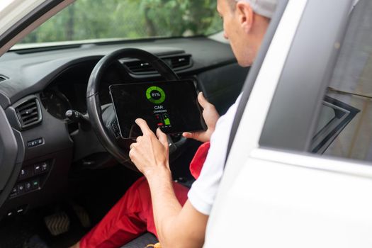 Close-up Of A Car Mechanic Using Digital Tablet.