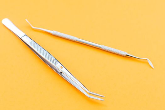 Dentist tools. Teethcare, dental health concept. orange background top view copy space.