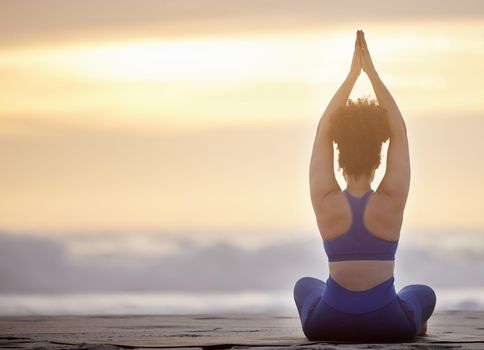 Yoga transforms the person. a unrecognizable female doing yoga on the beach