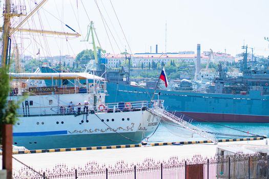 RUSSIA, CRIMEA - JUL 08, 2022: Sevastopol Hersones panorama view aerial evening bay port sea water black, concept ship transport from navy from dock military, air russian. Defense transportation crimean, coastline