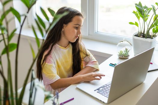 Excited Teen Girl Sitting In Living Room With Laptop, During Webinar At Home. Online School Tests Concept.