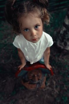 Portraits of a little girl on the playground with figures. High quality photo