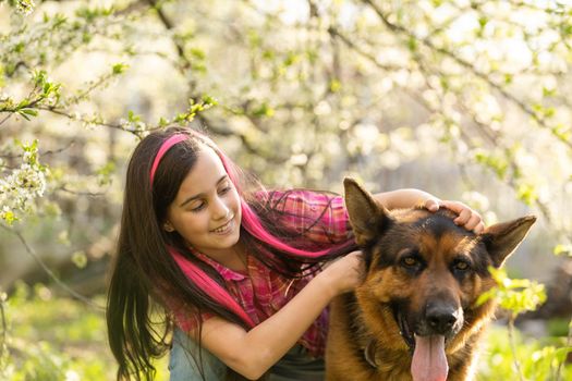 Little cute girl embracing and resting on shoulder dog